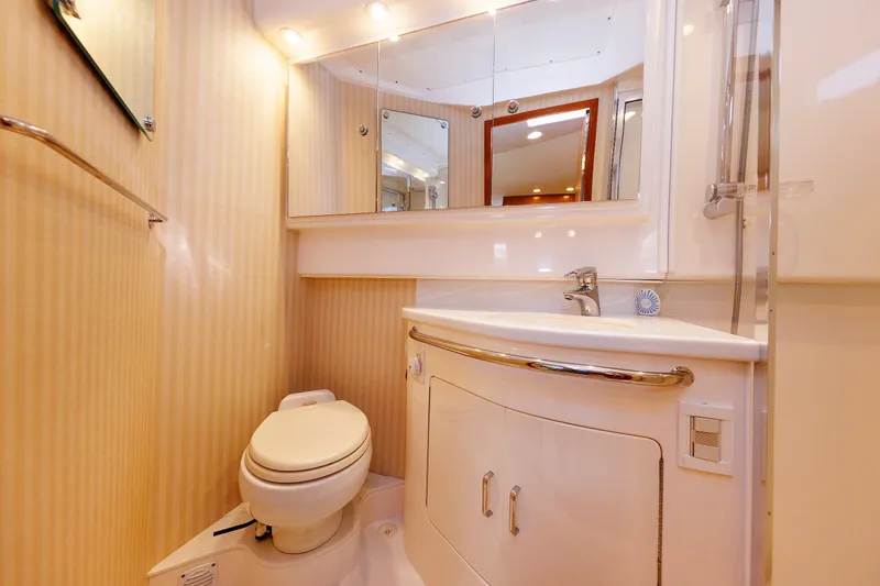 Slide: The Image of Luxurious bathroom in a 2006 Cabo Yachts 40 Express, featuring modern fixtures and elegant design. - 37