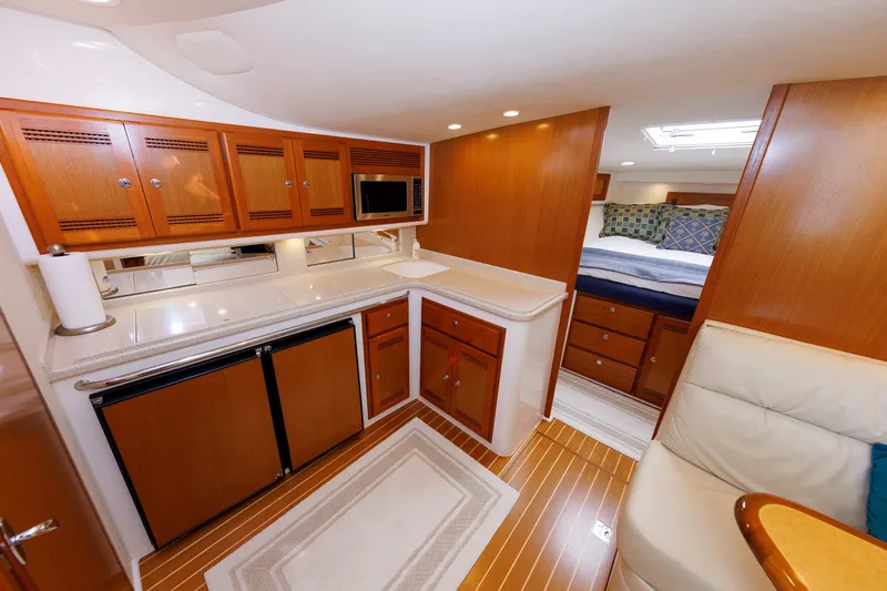 Slide: The Image of Luxurious interior of 2006 Cabo Yachts 40 Express with kitchen and cozy sleeping area. - 27