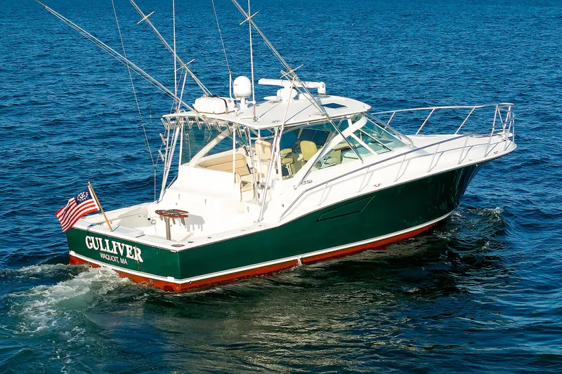 Slide: The Image of 2006 Cabo Yachts 40 Express cruising on open water, displaying American flag. - 1
