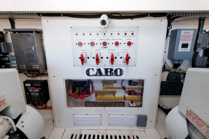 Slide: The Image of Electrical control panel of a 2006 Cabo Yachts 40 Express boat, featuring switches and wiring. - 49
