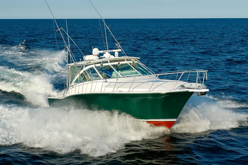 Slide: The Image of 2006 Cabo Yachts 40 Express cruising on open ocean waters. - 6