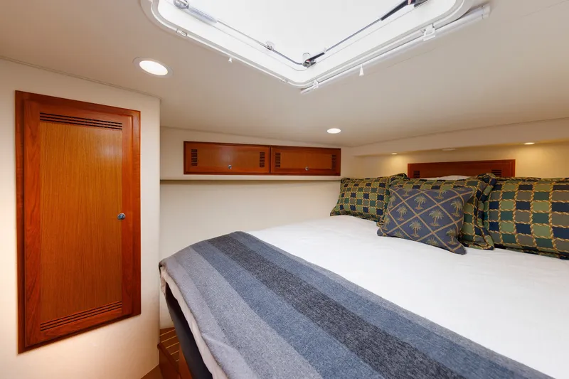 Slide: The Image of Luxurious cabin interior of 2006 Cabo Yachts 40 Express with cozy bedding and wooden accents. - 33
