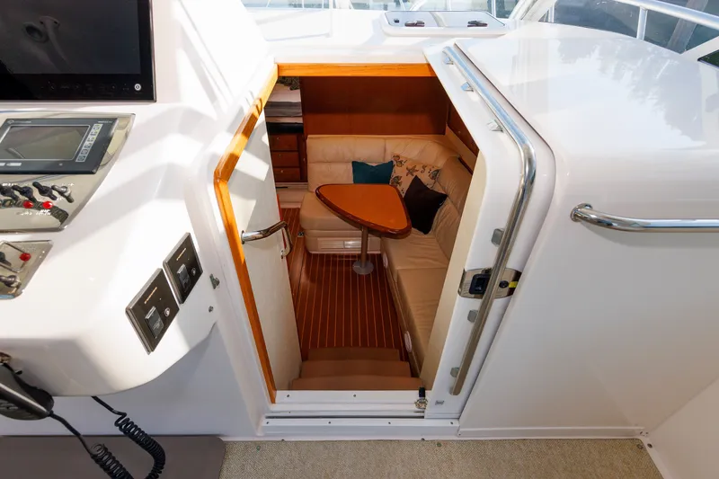 Slide: The Image of 2006 Cabo Yachts 40 Express interior with cozy seating and wooden table. - 23