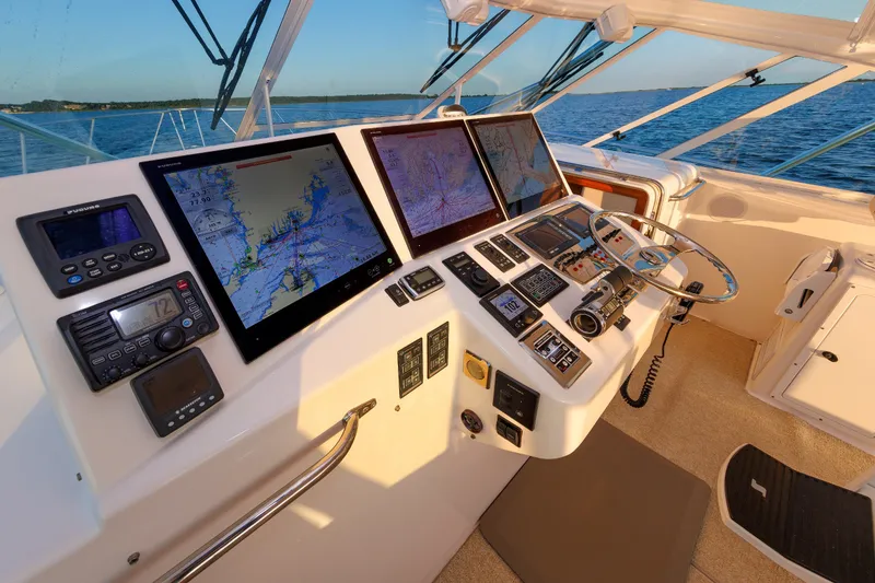 Slide: The Image of Helm of 2006 Cabo Yachts 40 Express with navigation screens and controls. - 21