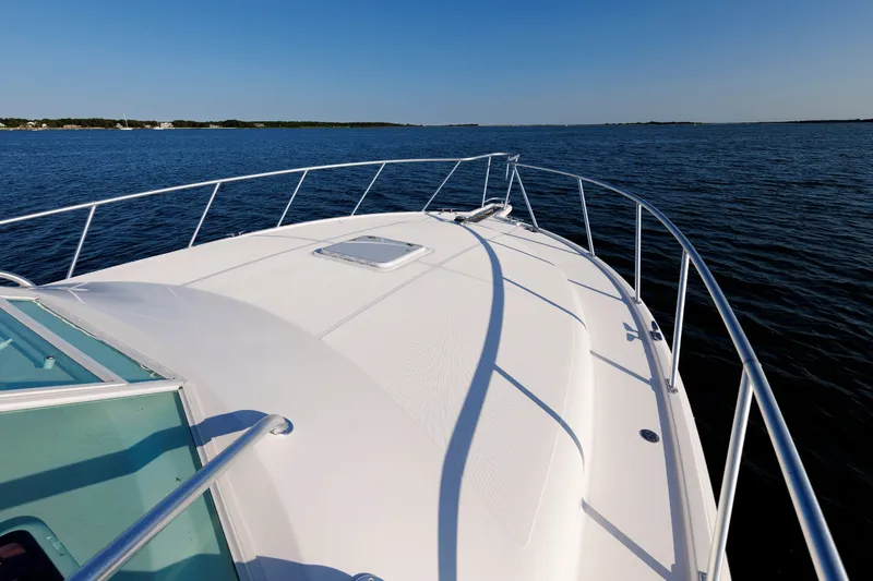 Slide: The Image of 2006 Cabo Yachts 40 Express boat deck on calm ocean waters. - 38
