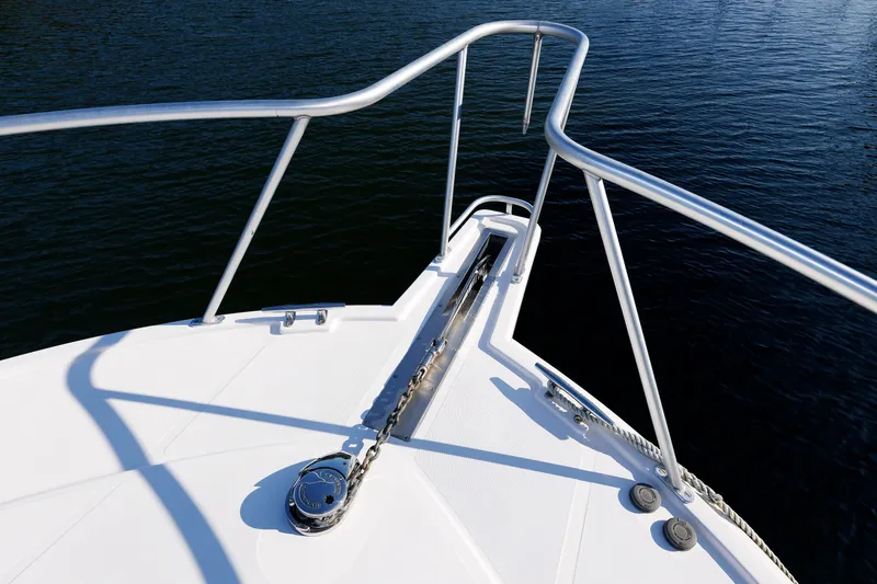 Slide: The Image of Bow of 2006 Cabo Yachts 40 Express, featuring stainless steel railings over water. - 41