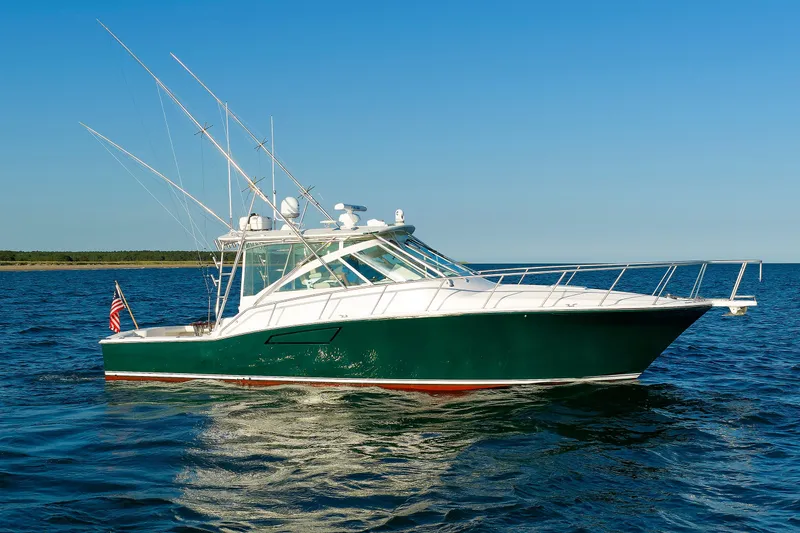 Slide: The Image of 2006 Cabo Yachts 40 Express cruising on open water under clear blue skies. - 2