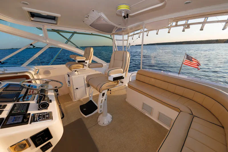 Slide: The Image of Luxurious 2006 Cabo Yachts 40 Express interior with helm, seating, and ocean view. - 15