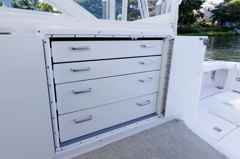 Slide: The Image of Storage drawers on a 2006 Cabo Yachts 40 Express boat, open to reveal sleek design. - 13