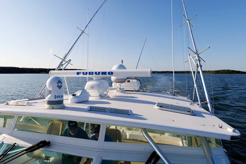 Slide: The Image of 2006 Cabo Yachts 40 Express on water, featuring advanced navigation equipment. - 43