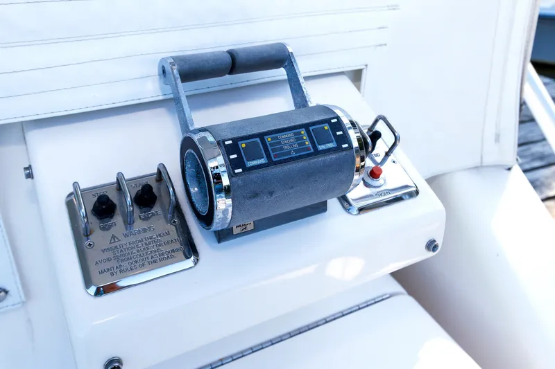 Slide: The Image of Control panel of a 2006 Cabo Yachts 40 Express boat, featuring throttle and switches. - 22