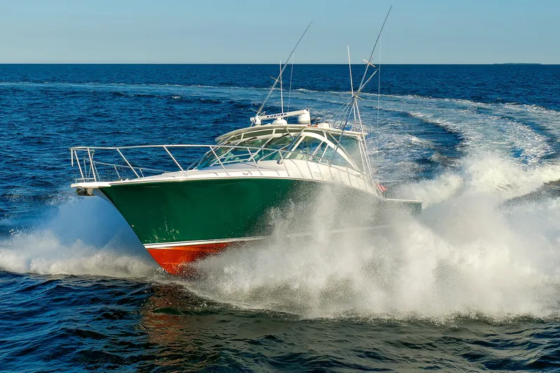 Slide: The Image of 2006 Cabo Yachts 40 Express cruising swiftly on open ocean waters. - 7