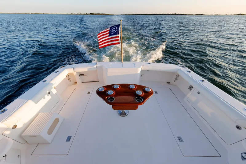 Slide: The Image of 2006 Cabo Yachts 40 Express cruising with American flag on open water. - 8