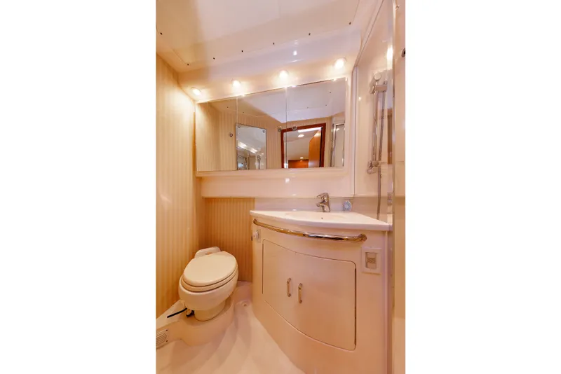 Slide: The Image of Luxurious bathroom in a 2006 Cabo Yachts 40 Express, featuring modern fixtures and elegant design. - 36