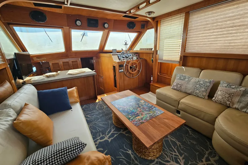 Slide: The Image of Interior of 1986 Jefferson 42 SE Sundeck Motor Yacht with cozy seating and wooden helm. - 32
