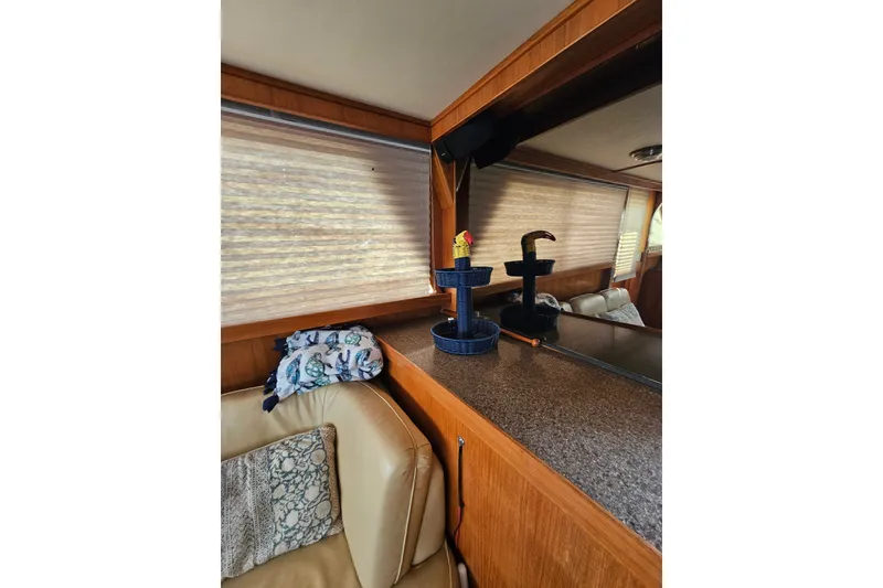 Slide: The Image of Interior of 1986 Jefferson 42 SE Sundeck Motor Yacht with cozy seating and decor. - 28