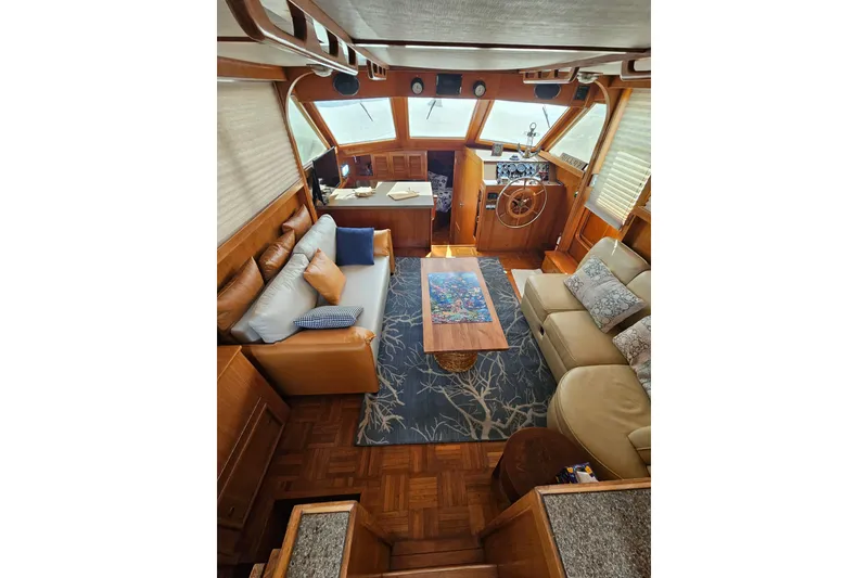 Slide: The Image of Luxurious interior of 1986 Jefferson 42 SE Sundeck Motor Yacht with elegant seating and helm. - 25