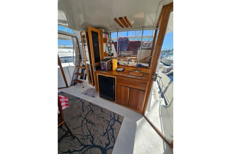 Slide: The Image of Interior of 1986 Jefferson 42 SE Sundeck Motor Yacht with wooden cabinetry and nautical decor. - 23