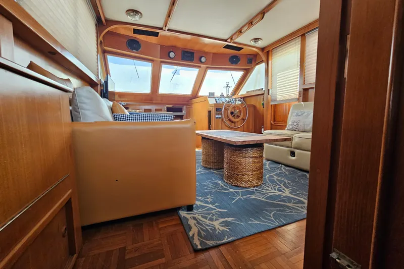 Slide: The Image of Interior of 1986 Jefferson 42 SE Sundeck Motor Yacht with cozy seating and nautical decor. - 31
