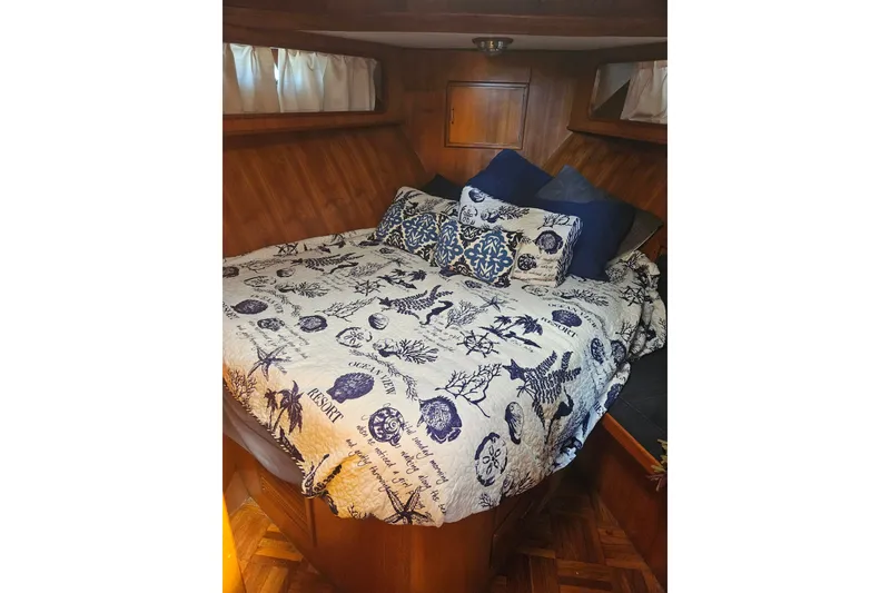 Slide: The Image of Cozy bedroom in 1986 Jefferson 42 SE Sundeck Motor Yacht with nautical-themed bedding. - 9