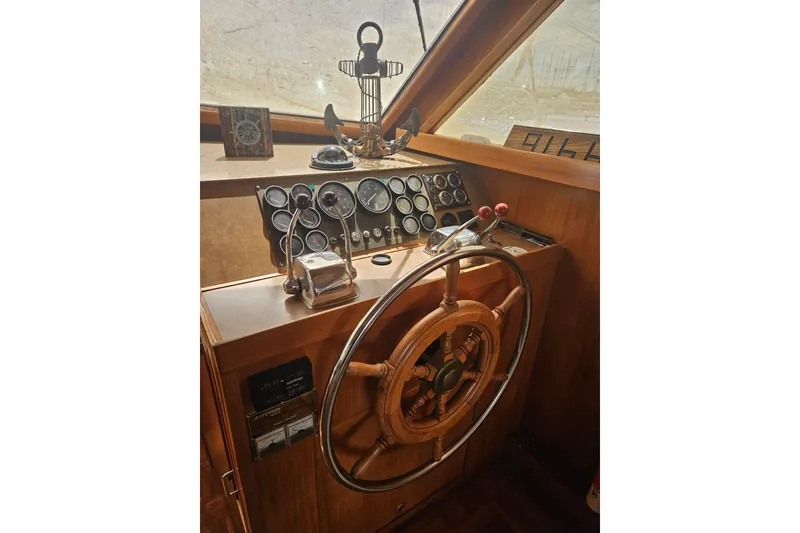 Slide: The Image of Helm of 1986 Jefferson 42 SE Sundeck Motor Yacht with wooden wheel and gauges. - 6