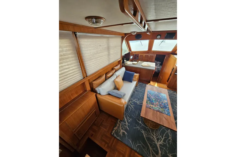 Slide: The Image of Interior of 1986 Jefferson 42 SE Sundeck Motor Yacht with cozy seating and nautical decor. - 26