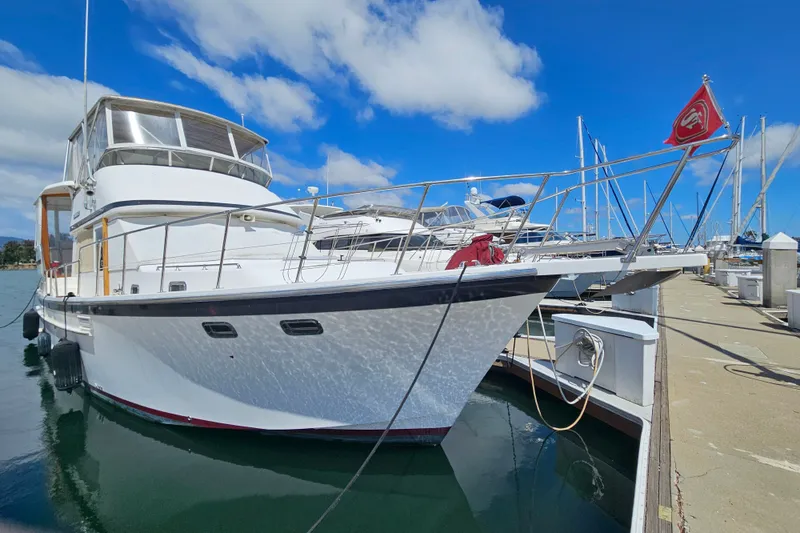 Slide: The Image of 1986 Jefferson 42 SE Sundeck Motor Yacht docked at marina under blue sky. - 4