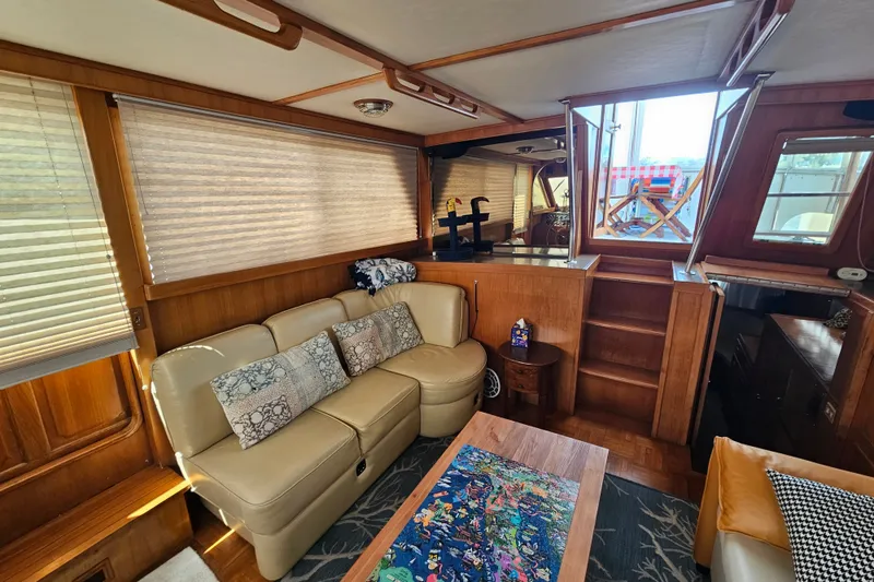 Slide: The Image of Interior of 1986 Jefferson 42 SE Sundeck Motor Yacht with cozy seating and wooden accents. - 33