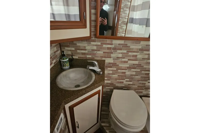 Slide: The Image of Bathroom interior of 1986 Jefferson 42 SE Sundeck Motor Yacht with sink and toilet. - 16
