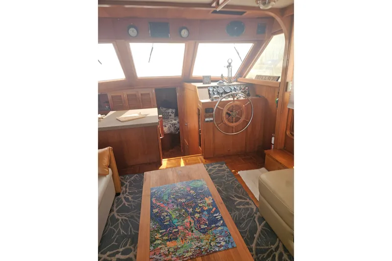 Slide: The Image of Interior of 1986 Jefferson 42 SE Sundeck Motor Yacht with wooden helm and seating area. - 5