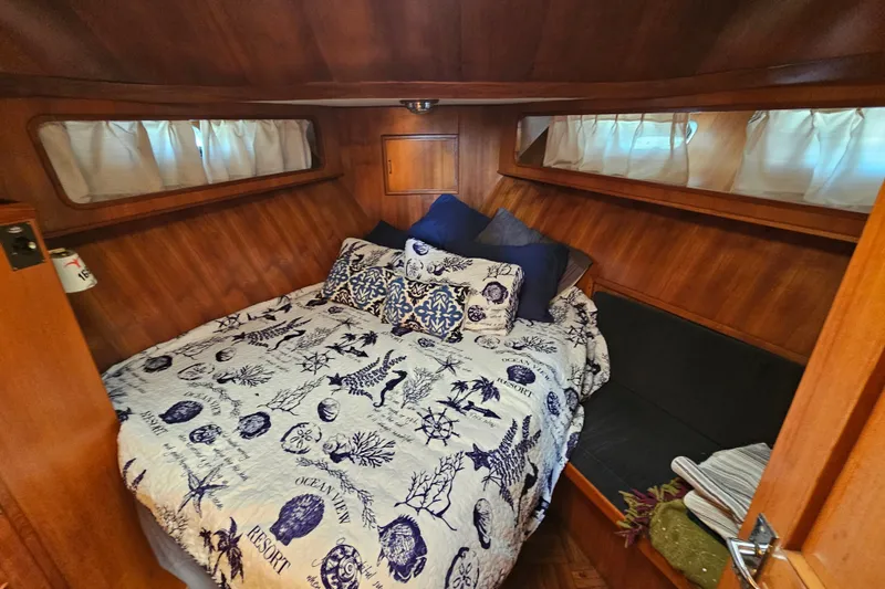 Slide: The Image of Cozy cabin interior of 1986 Jefferson 42 SE Sundeck Motor Yacht with nautical-themed bedding. - 36