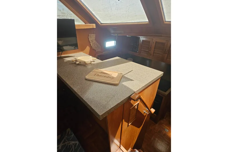 Slide: The Image of Interior of 1986 Jefferson 42 SE Sundeck Motor Yacht with countertop and wooden cabinetry. - 7