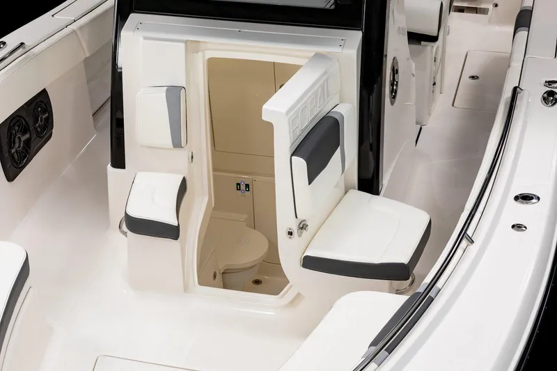Slide: The Image of Manufacturer Provided Image: 2025 Robalo R300 Center Console boat interior with seating and compact restroom. - 5