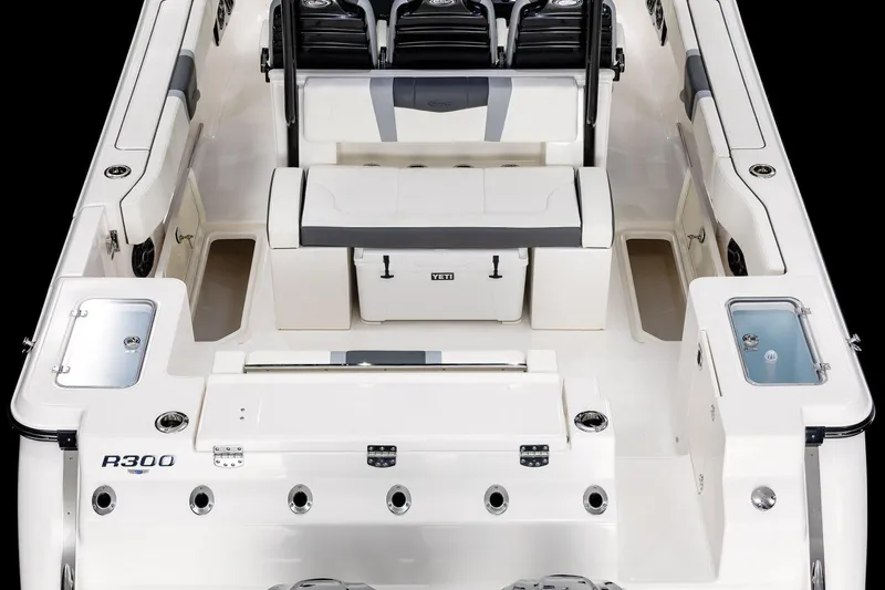 Slide: The Image of Manufacturer Provided Image: 2025 Robalo R300 Center Console boat interior with seating and storage compartments. - 9