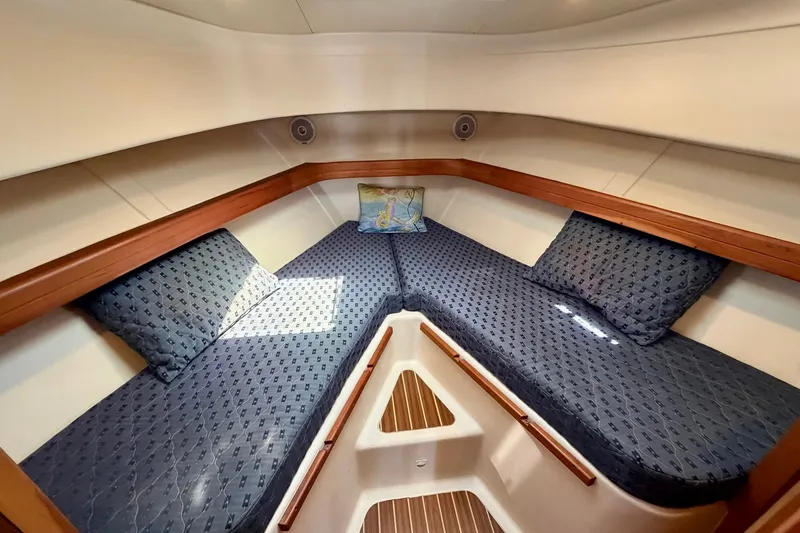 Slide: The Image of 2006 Mainship Pilot 34 Sedan cabin with cozy V-berth and nautical decor. - 18