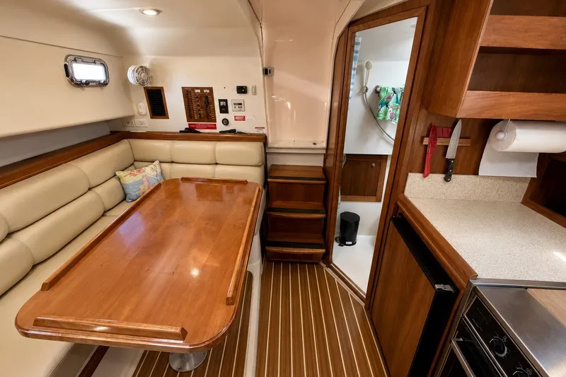 Slide: The Image of Interior of 2006 Mainship Pilot 34 Sedan with dining area and kitchenette. - 13