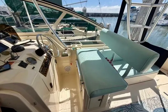 Slide: The Image of 2006 Mainship Pilot 34 Sedan helm with dual seating and marina view. - 10
