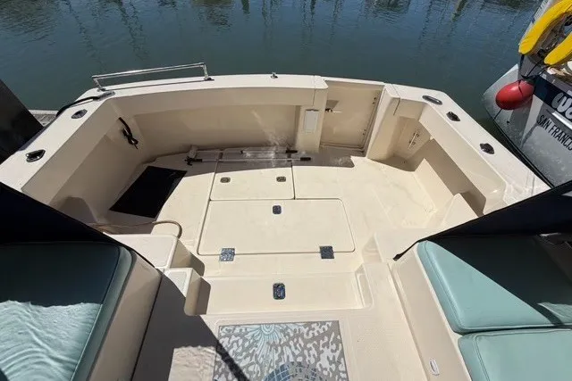 Slide: The Image of 2006 Mainship Pilot 34 Sedan boat deck with seating, storage, and water view. - 7