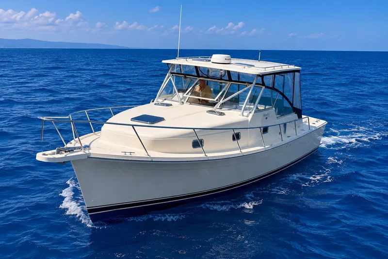 Slide: The Image of 2006 Mainship Pilot 34 Sedan cruising on open blue sea under clear sky. - 3