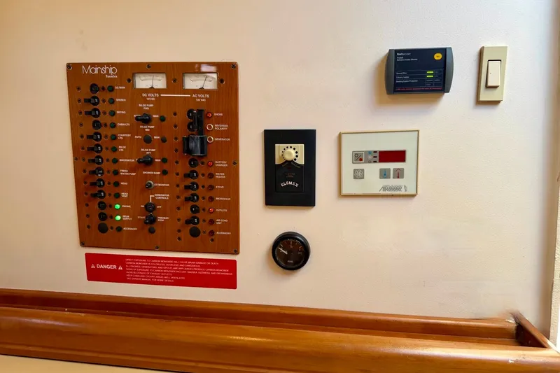 Slide: The Image of Control panel of a 2006 Mainship Pilot 34 Sedan boat, featuring various switches and gauges. - 21