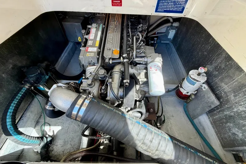 Slide: The Image of Engine compartment of a 2006 Mainship Pilot 34 Sedan, showcasing detailed mechanical components. - 22