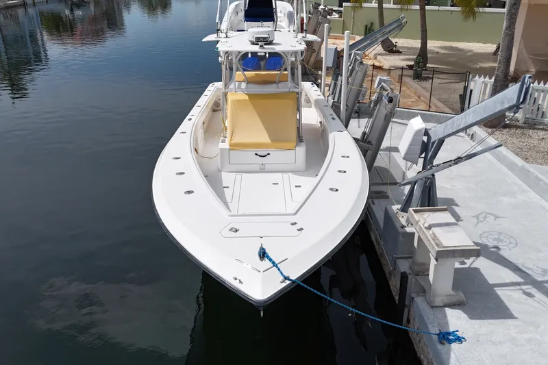 Slide: The Image of 2006 SeaVee 340B boat docked, featuring a spacious deck and sleek design. - 13
