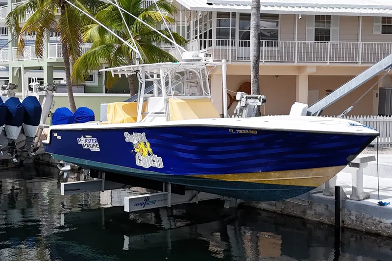 The Image of 2006 SeaVee 340B boat named "Sweet Catch" docked near waterfront homes. - 0