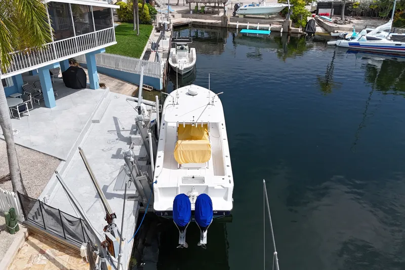 Slide: The Image of Aerial view of a 2006 SeaVee 340B boat docked by a waterfront home. - 19