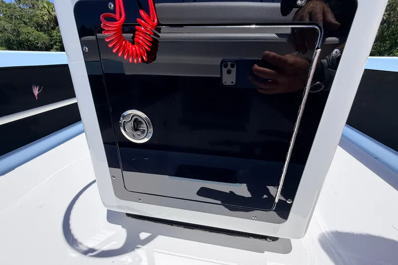 Slide: The Image of 2021 Chittum Skiffs Islamorada 21 console with red coiled safety lanyard. - 47
