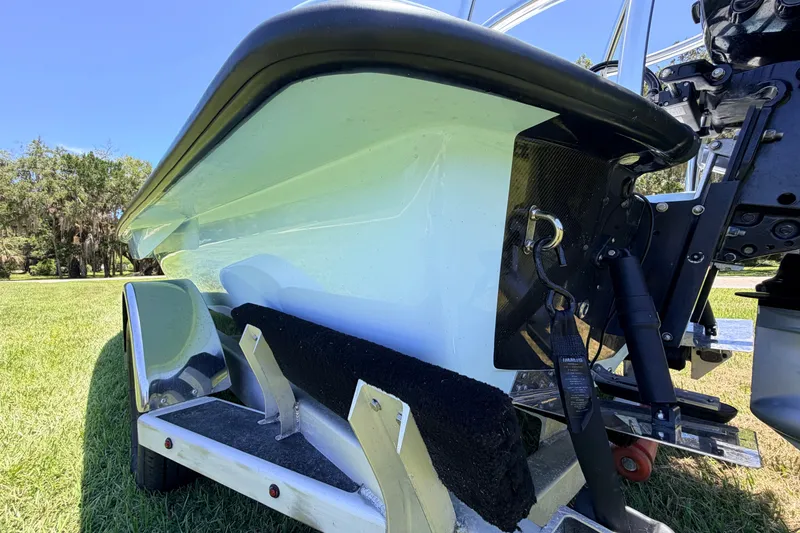 Slide: The Image of 2021 Chittum Skiffs Islamorada 21 boat on trailer, showcasing hull and motor details. - 14