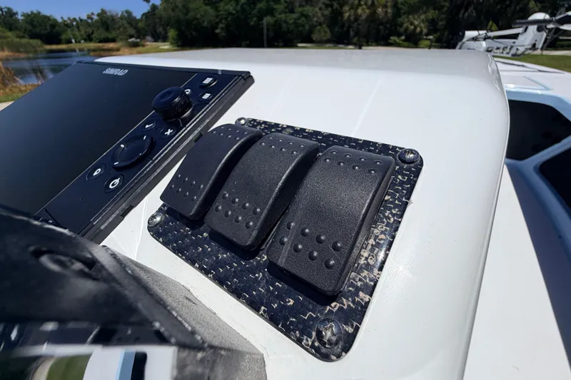 Slide: The Image of Control panel of 2021 Chittum Skiffs Islamorada 21 boat with switches and display. - 45