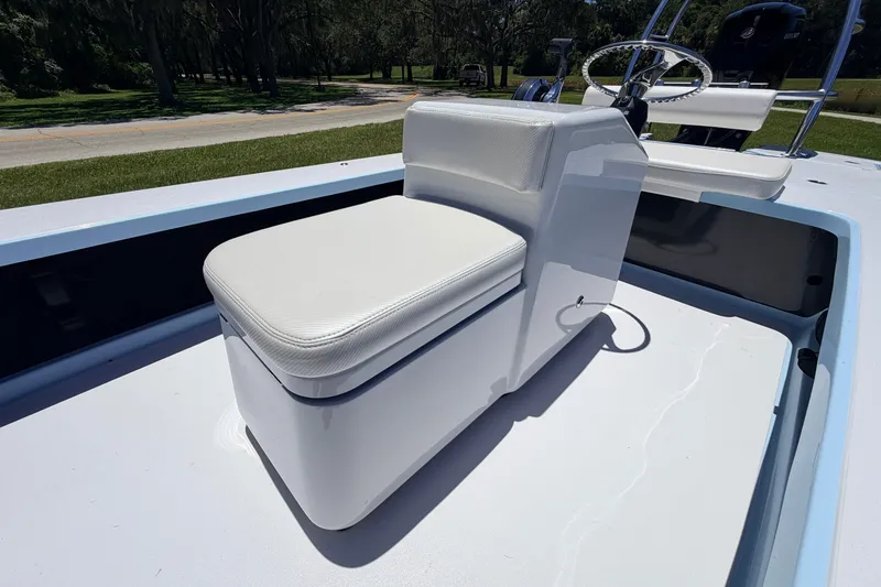 Slide: The Image of 2021 Chittum Skiffs Islamorada 21 boat interior with white cushioned seating and steering console. - 36