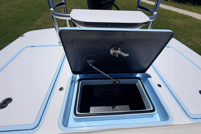 Slide: The Image of 2021 Chittum Skiffs Islamorada 21 boat with open storage compartment on deck. - 71