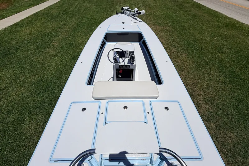 Slide: The Image of 2021 Chittum Skiffs Islamorada 21 boat on grass, showcasing deck and steering console. - 84